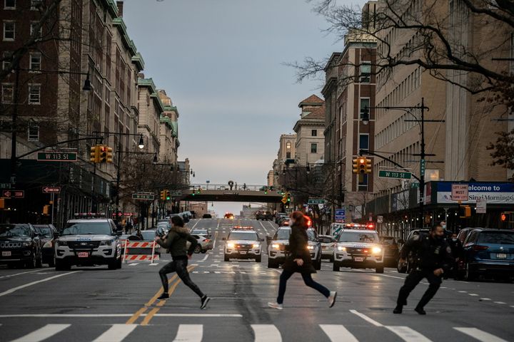 People run after a man opened fire outside the Cathedral Church of St. John the Divine in the Manhattan borough of New York City on December 13, 2020.