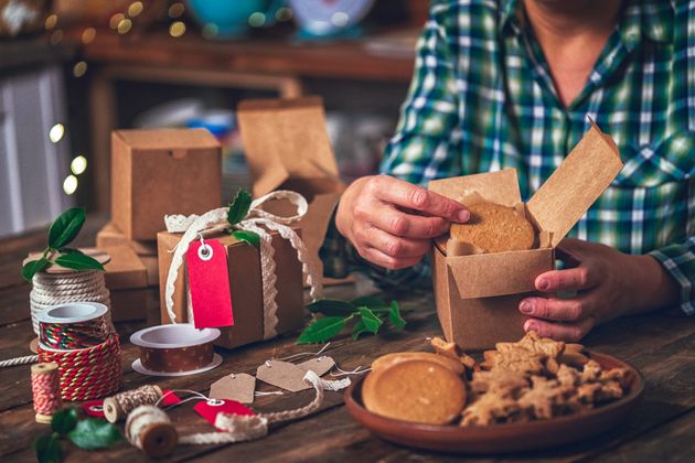 Wrapping and decorating Christmas presents for sending homemade cookies as a gift for Christmas.