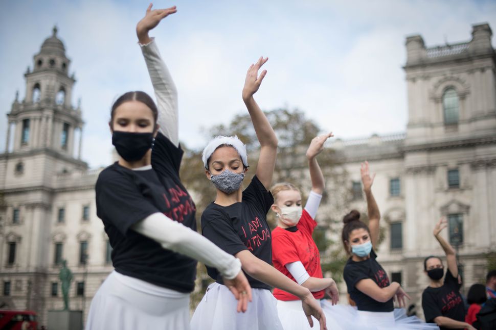 Young ballet dancers perform during a protest calling for more funding for the performing arts in Parliament Square, London. 