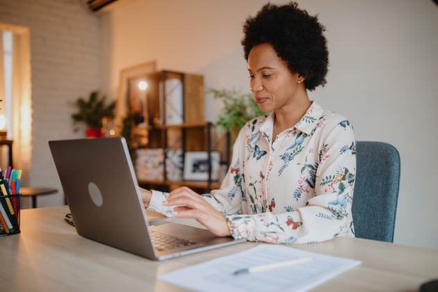 Hispanic woman working from home office. Latina woman working from home