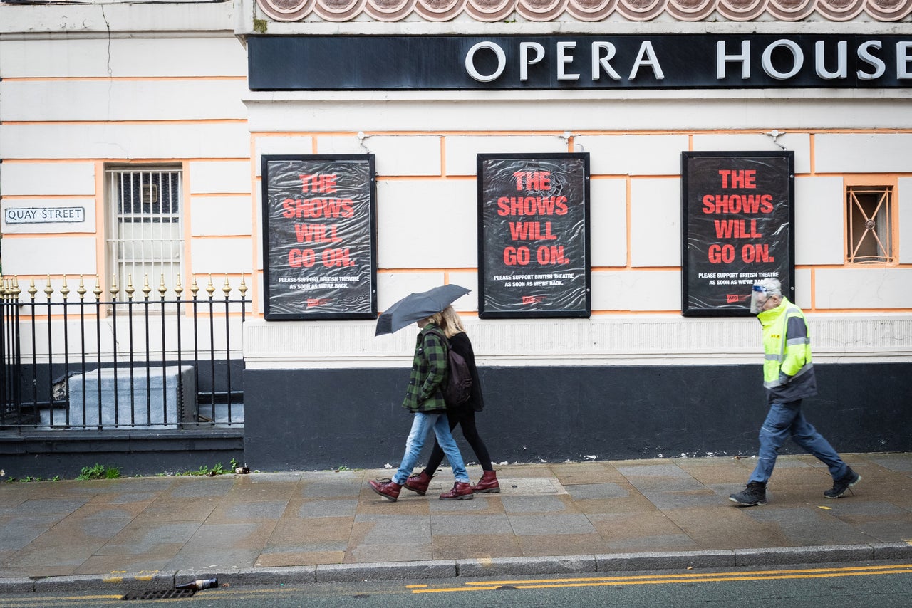 Members of the public walking past the Opera House theatre, which has been closed during Covid 19 pandemic.