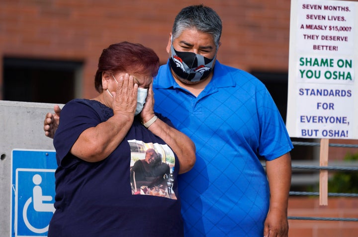 Carolina Sanchez, left, is comforted by her oldest son, Saul Jr., during a protest on Sept. 16, 2020, in downtown Denver that was staged by the union representing employees at a Colorado meatpacking plant where six workers died of COVID-19 and hundreds more were infected. 