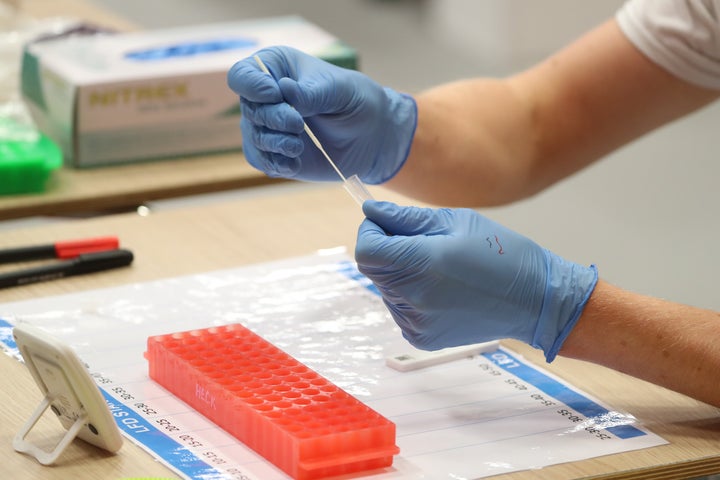 People carry out asymptomatic testing using lateral flow antigen at a test centre at Edinburgh University ahead of students being allowed to travel home for the Christmas holidays.