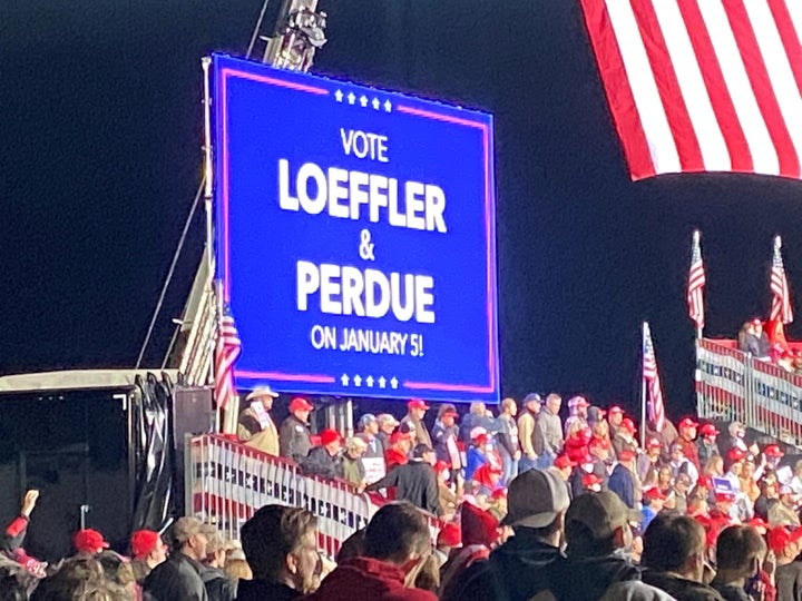 A digital sign urging people to vote for Republican senators facing critical runoff races on Jan. 5, 2021, during a rally for President Donald Trump in Valdosta, Georgia, on Dec. 5.