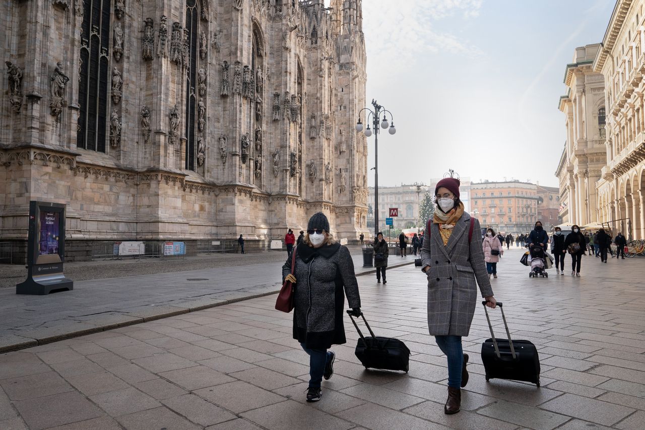 Two people walk in Duomo Square in Milan, Italy, on Dec. 14. The Italian government is expected to announce updated coronavirus guidance for Christmas gatherings this week.