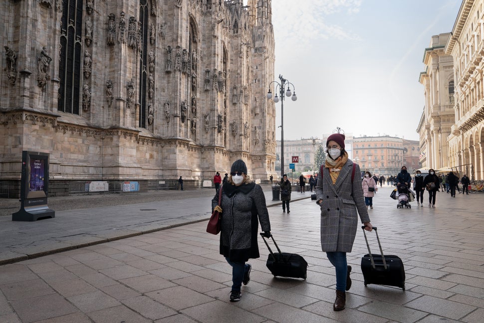 Two people walk in Duomo Square in Milan, Italy, on Dec. 14. The Italian government is expected to announce updated coronavir