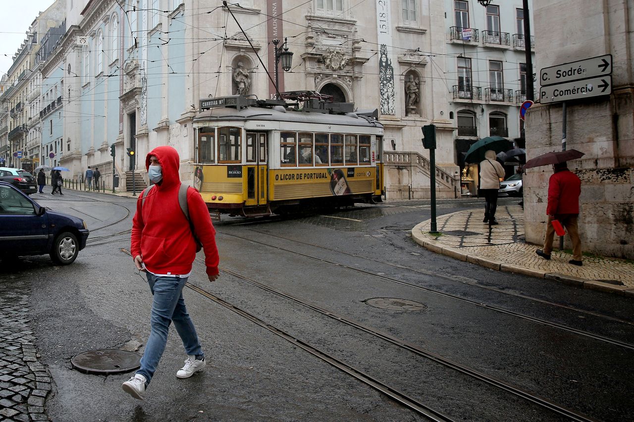 A man wearing a face mask walks in Lisbon, Portugal, on December 09, 2020. There will be no limit on how many people can gather per household for Christmas in Portugal.