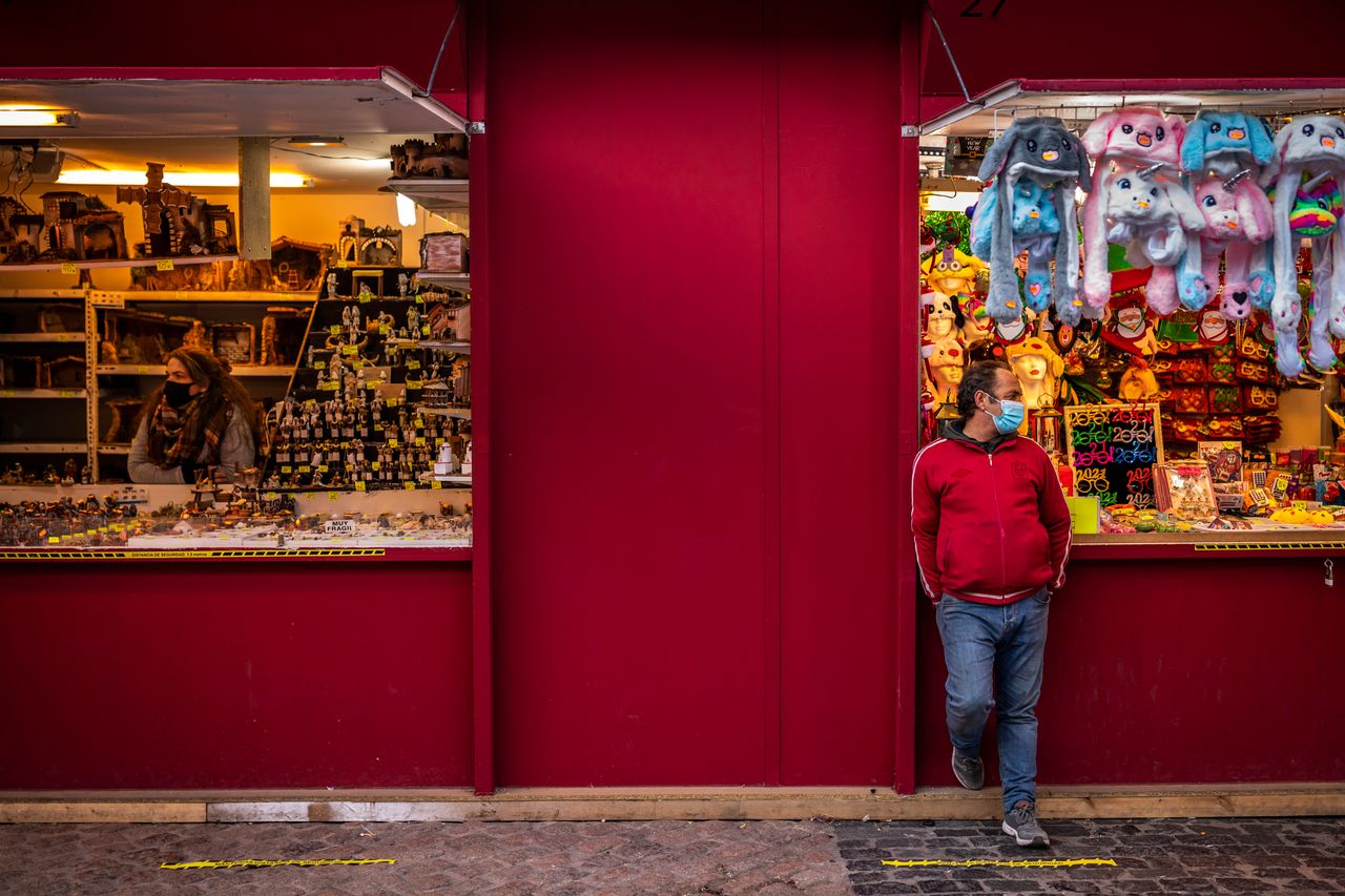 Vendors wait for customers at a Christmas market at the Plaza Mayor, Madrid, Spain. Prime minister Pedro Sanchez warned lawmakers on Wednesday that the government would issue stricter guidance if infection rates continued to climb.