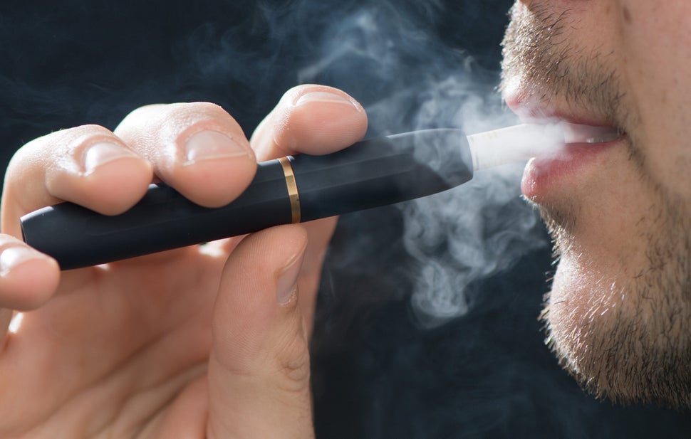 In Saxony, Dresden, a man smokes with the electronic tobacco heater IQOS (I quit ordinary smoking) made by the tobacco compan