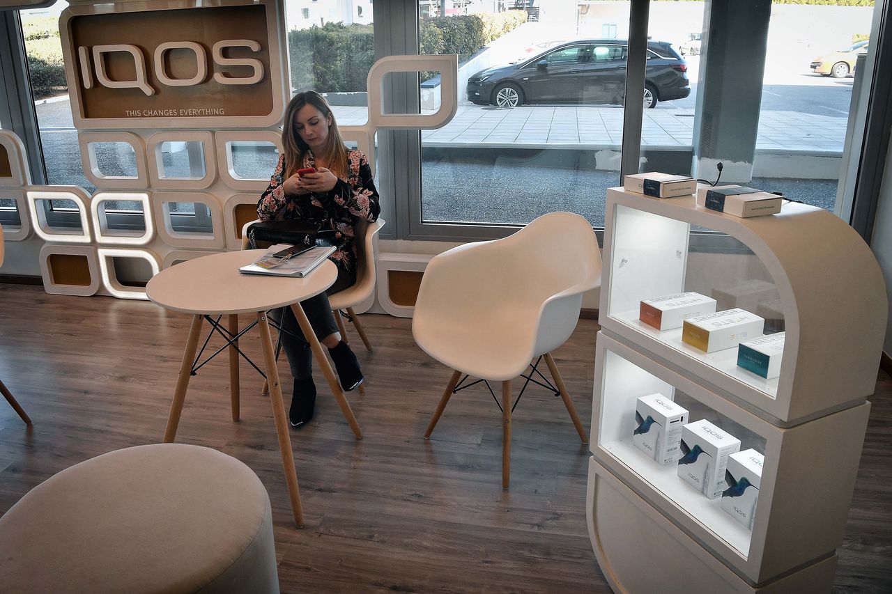 A woman sits in an IQOS lounge at the Papastratos tobbacco company facilities in Aspropyrgos, Greece. Philip Morris International bought Papastratos, Greece's largest tobacco company, in 2003.