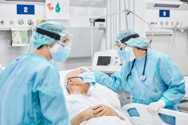 Doctors are seen caring for a patient in a stock photo.