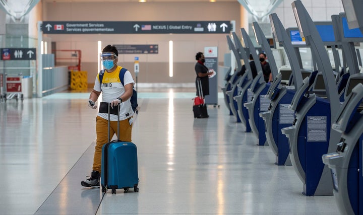 A passenger crosses an empty terminal at Toronto Pearson International Airport, June 23, 2020. Canada's population has all but stopped growing amid the COVID-19 pandemic, new data from Statistics Canada shows.