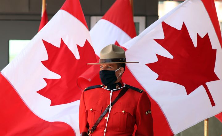 A Royal Canadian Mounted Police officer stands guard outside the Senate of Canada prior to the Speech from the Throne in Sept. 23, 2020 in Ottawa.