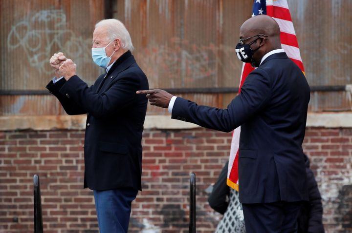 President-elect Joe Biden alongside Democratic Senate candidate Raphael Warnock during a drive-in campaign rally ahead of the Jan. 5 runoff elections, in Atlanta, Dec. 15.