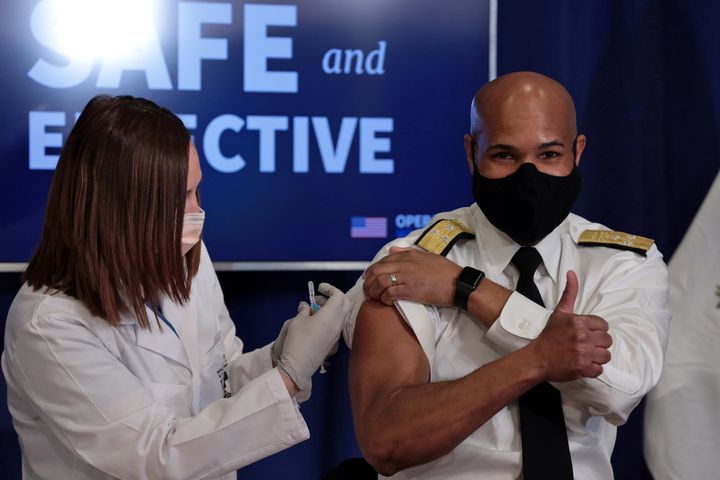 U.S. Surgeon General Jerome Adams gives the thumbs up as he receives the coronavirus disease (COVID-19) vaccine at the White House in Washington, U.S., December 18, 2020. REUTERS/Cheriss May