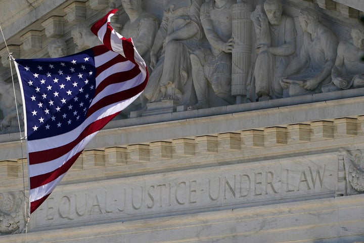 An American flag waves in front of the Supreme Court building, Monday, Nov. 2, 2020, on Capitol Hill in Washington. (AP Photo/Patrick Semansky)