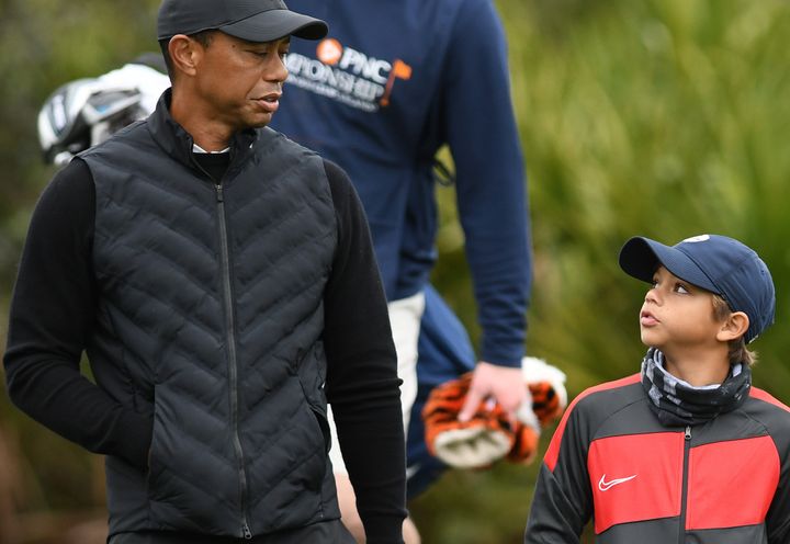 Tiger Woods and son Charlie talk things over at the 10th hole during a pro-am practice round before the PNC Championship.