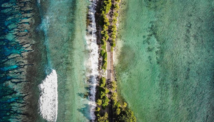 The narrowest point of Fongafale island, in Funafuti, Tuvalu. Scientists predict the low-lying South Pacific island nation could become inundated and uninhabitable in 50 to 100 years or less if sea level rise continues. 