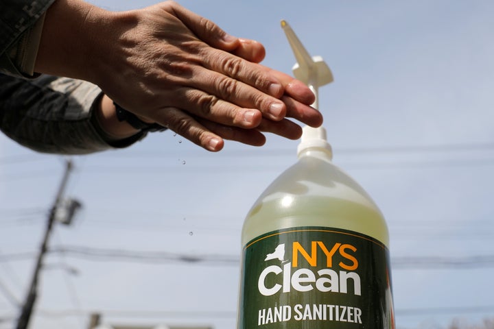 A member of the New York Army National Guard uses NYS Clean, a hand sanitizer created by the New York state government via prison labour in response to the coronavirus disease in New Rochelle, New York on March 18, 2020.