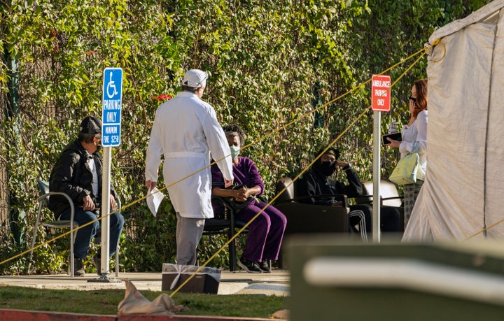 Patients wait in line for medical evaluation next to medical tents set at the CHA Hollywood Presbyterian Medical Center in Lo