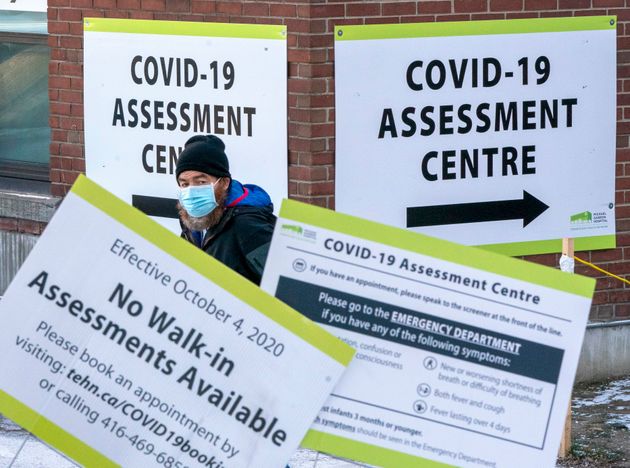 A man exits a COVID-19 Assessment Centre in Toronto on