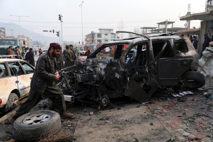 People gather near the site of a deadly bombing attack in Kabul, Afghanistan, Sunday, Dec. 20, 2020. (AP Photo/Rahmat Gul)