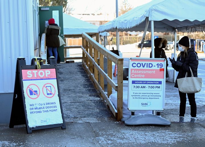People line up at a COVID-19 assessment center on Dec. 2, 2020, in Scarborough, Ont.