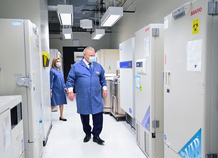 Ontario Premier Doug Ford, front, and Ontario Health Minister Christine Elliott look at freezers ahead of COVID-19 vaccine distribution in Toronto on Dec. 8, 2020.