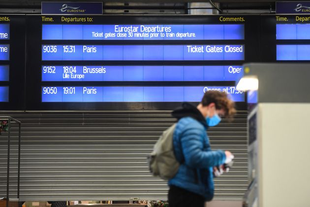 A man is seen buying tickets at St Pancras train station on Sunday in