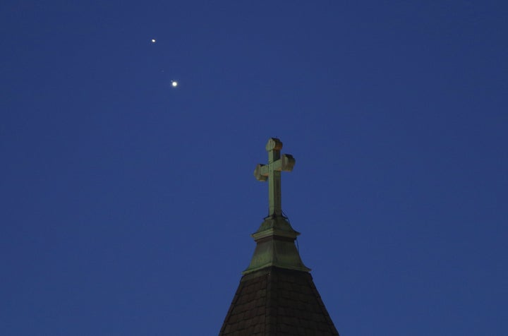 Saturn and Jupiter set behind a church ahead of their conjunction that is being called The Christmas Star next week on December 18, 2020 in Jersey City, New Jersey. 