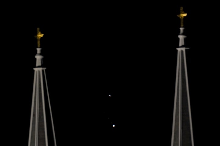 Saturn, top, and Jupiter, below, are framed between the twin steeples of St. Joseph Catholic Church Saturday, Dec. 19, 2020 in Topeka, Kansas, USA.