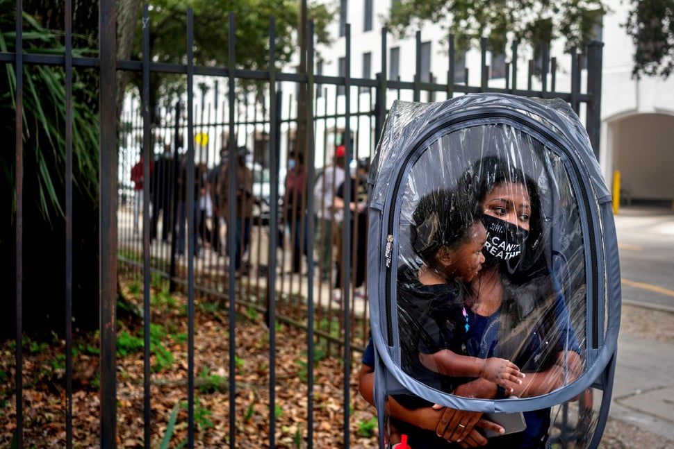 Dana Clark and her 18-month-old son, Mason, wait in line on Oct. 16 at City Hall as early voting begins for the U.S. presiden