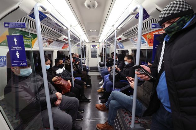 Commuters travelling on the morning rush hour in London, which has moved into the highest tier of coronavirus restrictions as a result of soaring case rates.