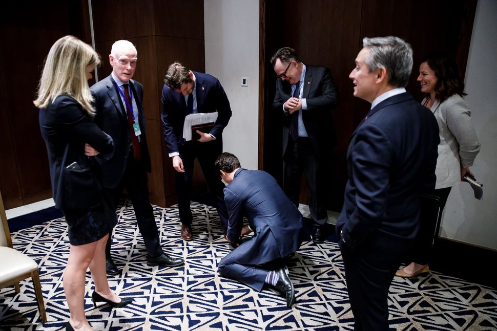 "PM Trudeau helps out advisor Patrick Travers by tying his shoelace," said Scotti, who took the photo in Addis Ababa on Feb. 10, 2020. 