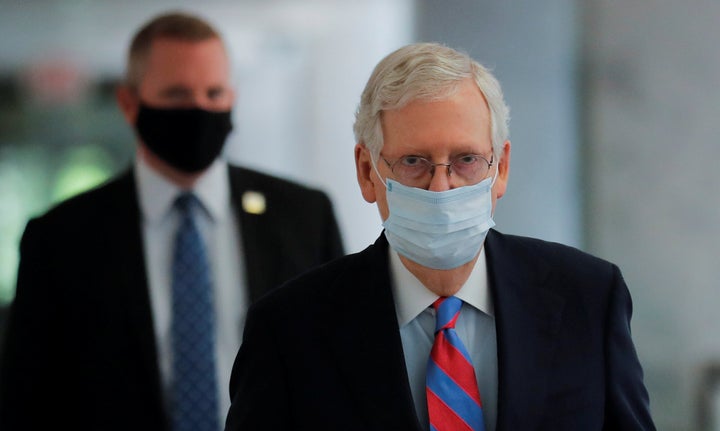 Senate Majority Leader Mitch McConnell (R-Ky.) wears a protective face mask as he walks down a hallway of the Hart Senate Office Building in Washington, May 12, 2020.