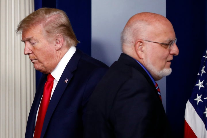 President Donald Trump passes Dr. Robert Redfield, director of the Centers for Disease Control and Prevention, during a briefing about the coronavirus in this April 22 file photo. (AP Photo/Alex Brandon, File)