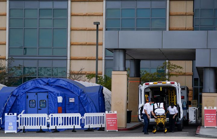 Medical workers remove a stretcher from an ambulance near medical tents outside the emergency room at UCI Medical Center, in Irvine, Calif., on Thursday.