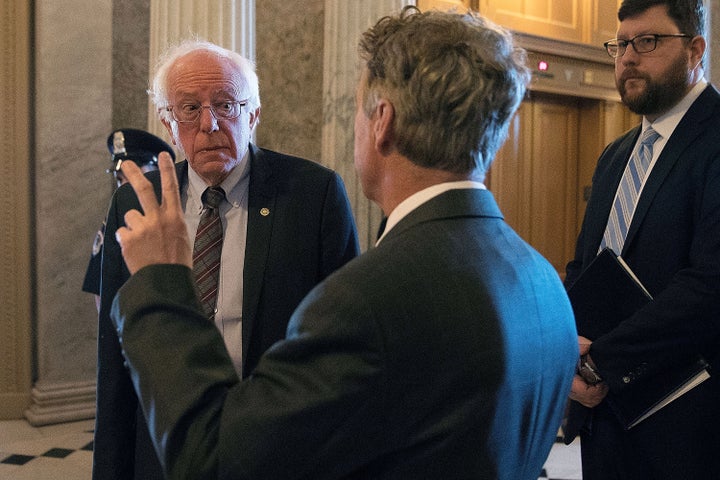 Sen. Bernie Sanders (I-Vt.), left, talks with Sen. Rand Paul (R-Ky.) in April 2018. Paul has called for pardoning Snowden, while Sanders backs leniency, rather than a full pardon.