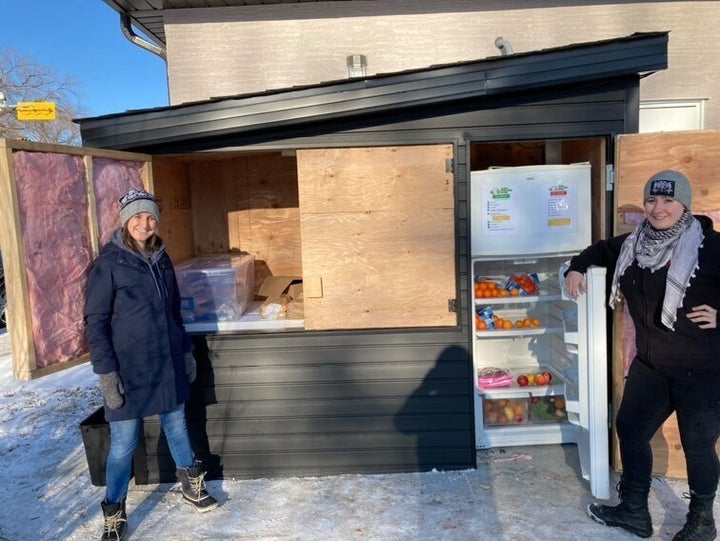 Danielle Froh and Brianna Kroener stand in front of the Regina Community Fridge, a hunger relief pilot project the two launched earlier this month.