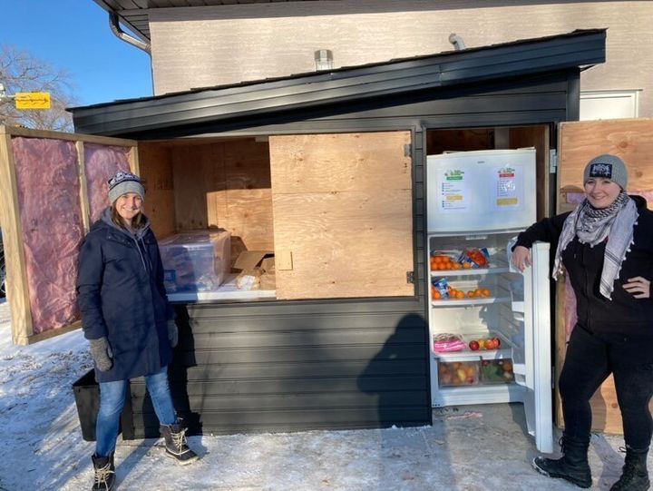 Danielle Froh and Brianna Kroener stand in front of the Regina Community Fridge, a hunger relief pilot project the two launched earlier this month.