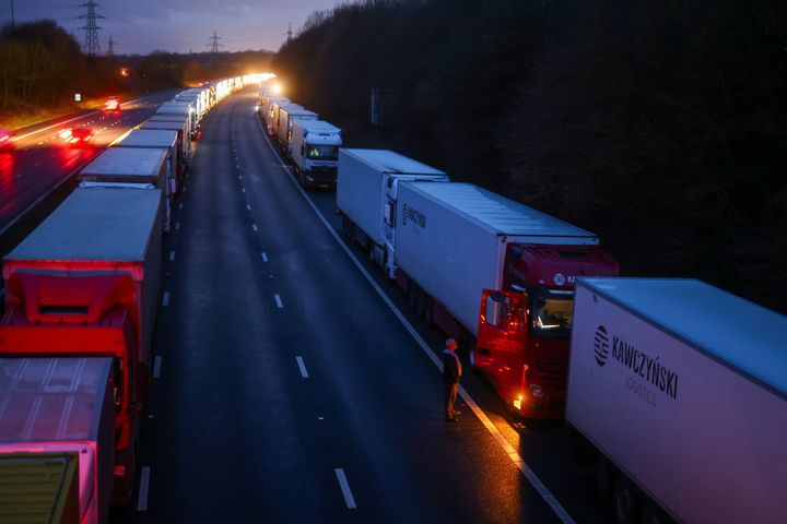 A man stands next to a lorry parked on the M20 motorway on December 22.