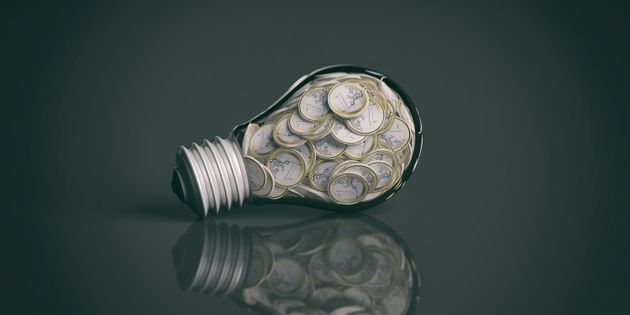3d rendering coins inside a light bulb on black