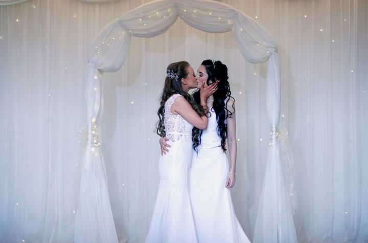 Sharni Edwards, 27, and Robyn Peoples, 26, a Belfast couple who are the first known same-sex couple to get married in Northern Ireland, kiss after being married, in Carrickfergus, Northern Ireland, February 11, 2020