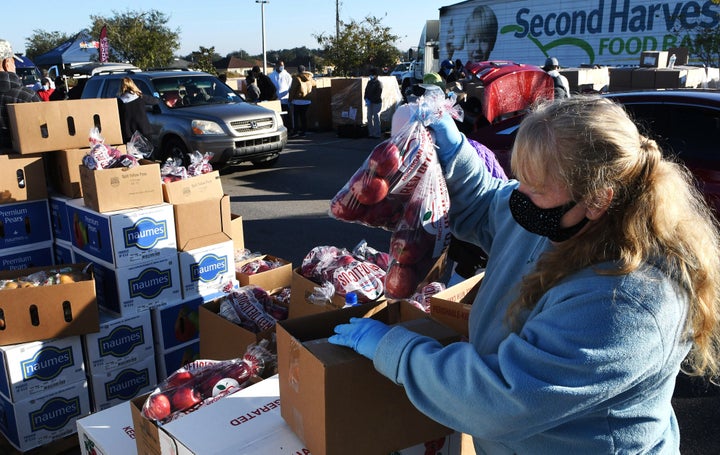 A volunteer prepares boxes of food assistance at a food distribution event in Groveland, Florida, on Dec. 9.