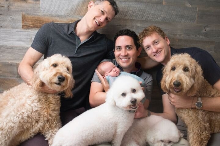 Ian, Alan and Jeremy with their daughter, Piper, and four dogs.