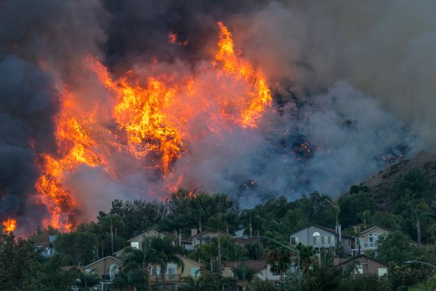 Flames rise near homes during the Blue Ridge fire on Oct. 27 in Chino Hills,