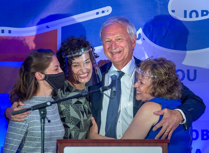 New Brunswick Premier Blaine Higgs embraces his wife Marcia Higgs, right, and daughters Rachel Hiltz, left and Lindsey Higgs after winning the provincial election in Quispamsis, N.B. on Sept. 14, 2020.