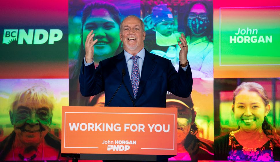 NDP Leader John Horgan celebrates his election win in the British Columbia provincial election in downtown Vancouver, B.C., on Oct. 24, 2020.