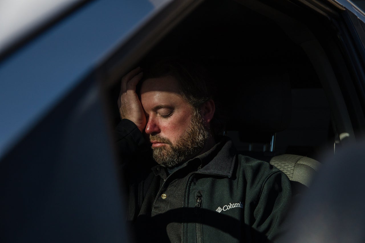 Mike Kurtz sits in his truck to decompress for a few minutes after working more than 10 hours.