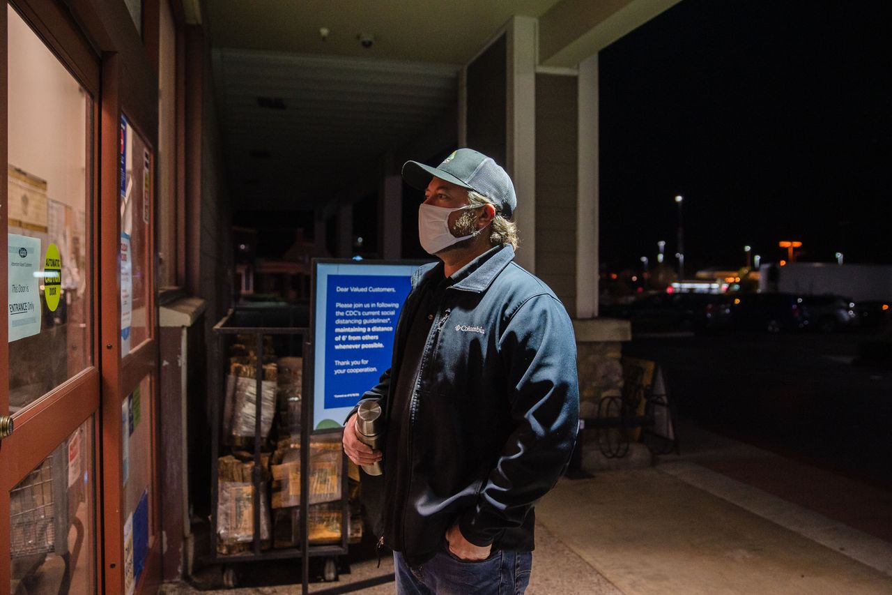 Mike Kurtz, a meat manager at a Ralphs on Carmel Mountain Road in San Diego, waits for an employee to let him in the store at 4 a.m. so he can start his shift.
